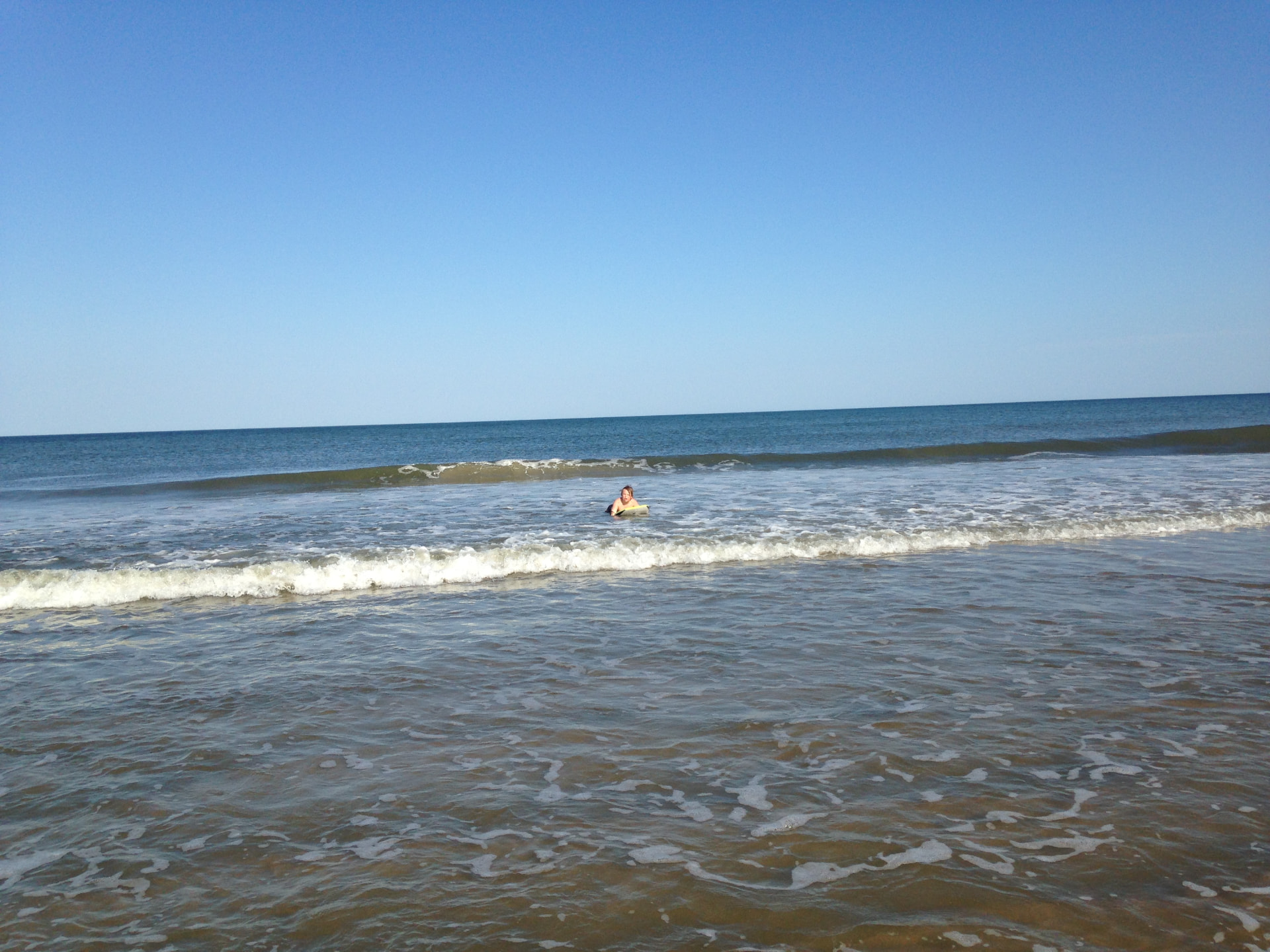Bodyboarder riding the shorebreak on an Ocean City, Maryland morning